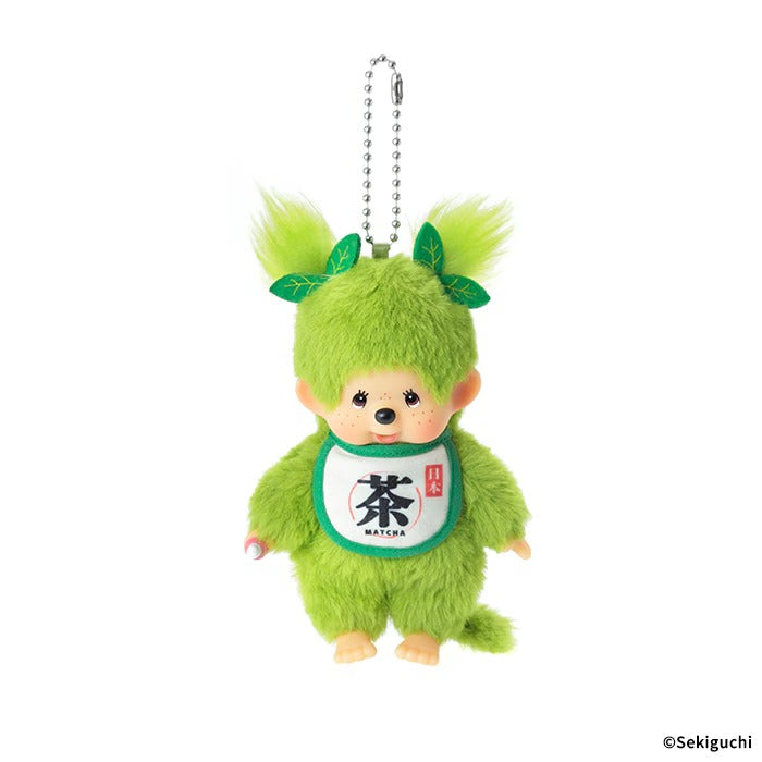 Matcha Monchhichi girl plush keychain, twin-tail design with tiny sprout leaf, matcha green fuzzy fabric, bib printed with "Cha", Japanese kawaii bag accessory
