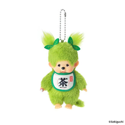 Matcha Monchhichi girl plush keychain, twin-tail design with tiny sprout leaf, matcha green fuzzy fabric, bib printed with "Cha", Japanese kawaii bag accessory