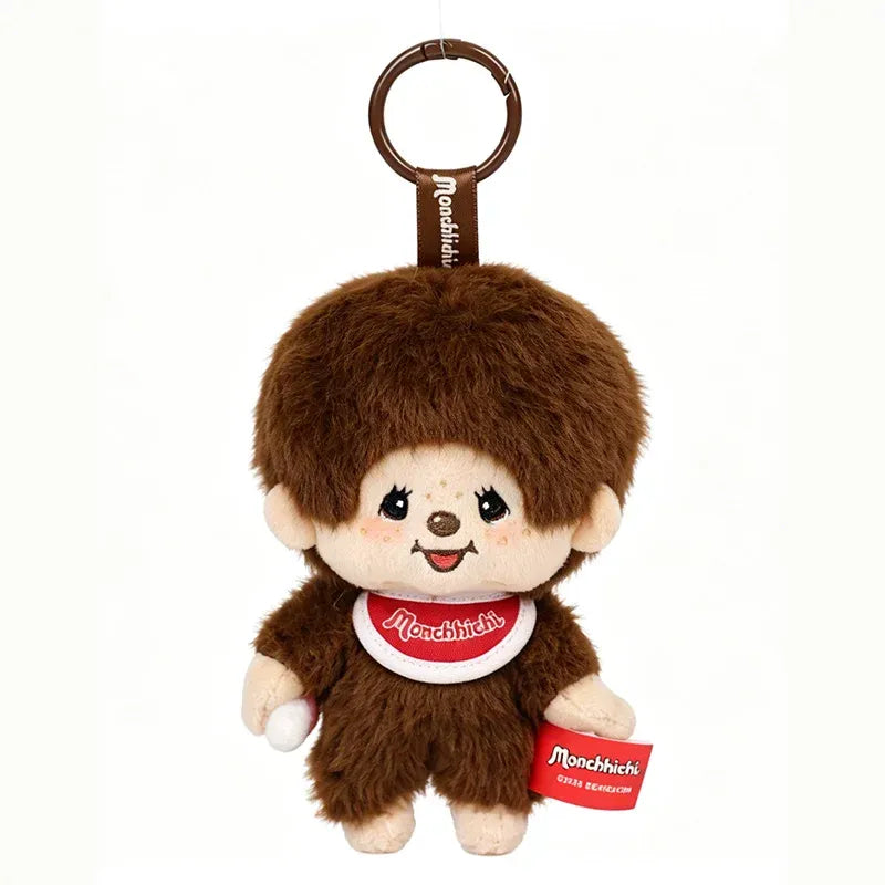 White background studio shot of Monchhichi x Miniso Mon Mon Farm Coffee Classic Boy Mini Plush Charm, 12cm fluffy monkey pendant with logo bib plastic carabiner hanging collectible toy display