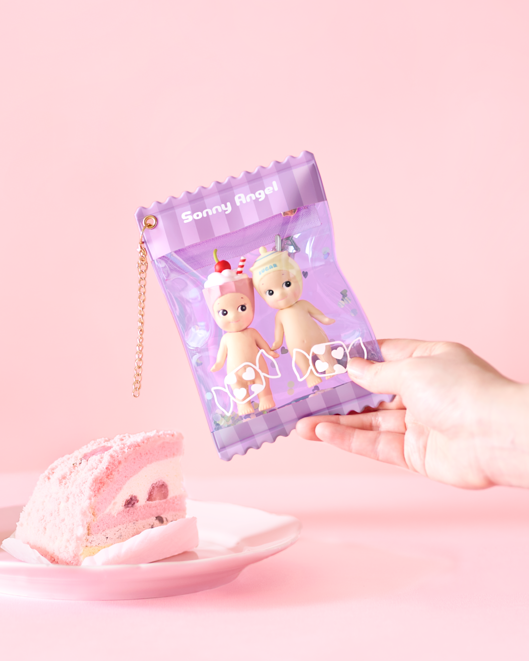 Purple Sonny Angel candy-shaped clear keychain pouch, kawaii doll storage bag with two dessert-themed figurines, cute collectible toy display case with chain charm